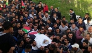 تسليم جثمان شهيد.jpg